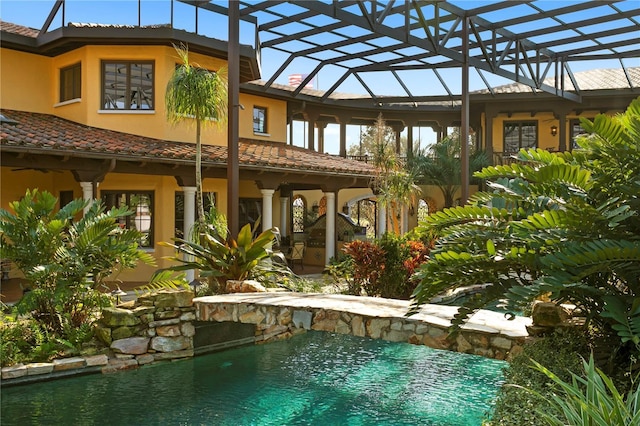 view of pool featuring glass enclosure