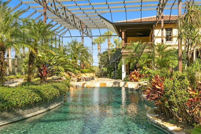 view of pool with a lanai and pool water feature