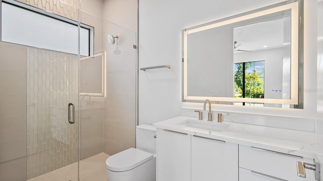 full bathroom with toilet, a stall shower, ceiling fan, and vanity