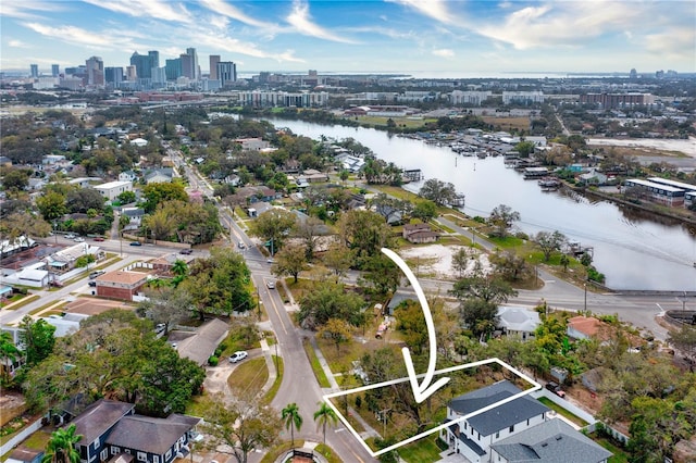 birds eye view of property with a water view and a view of city