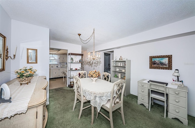 dining area with an inviting chandelier, a textured ceiling, and dark carpet