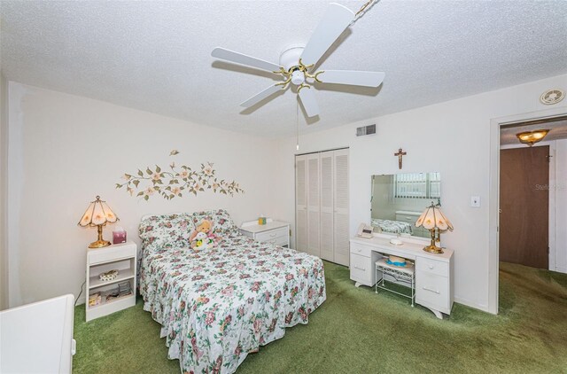 bedroom featuring ceiling fan, dark carpet, a closet, and a textured ceiling