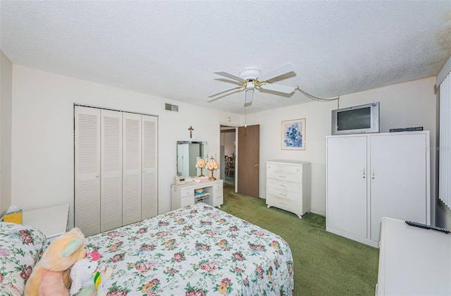 carpeted bedroom featuring ceiling fan, a closet, and a textured ceiling