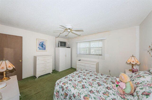 carpeted bedroom with ceiling fan and a textured ceiling