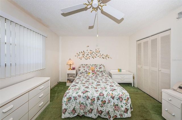 bedroom featuring ceiling fan, a textured ceiling, dark carpet, and a closet