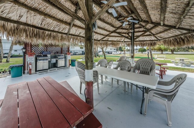 view of patio with a gazebo, ceiling fan, and exterior kitchen