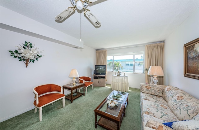 living room featuring a textured ceiling, carpet floors, and ceiling fan