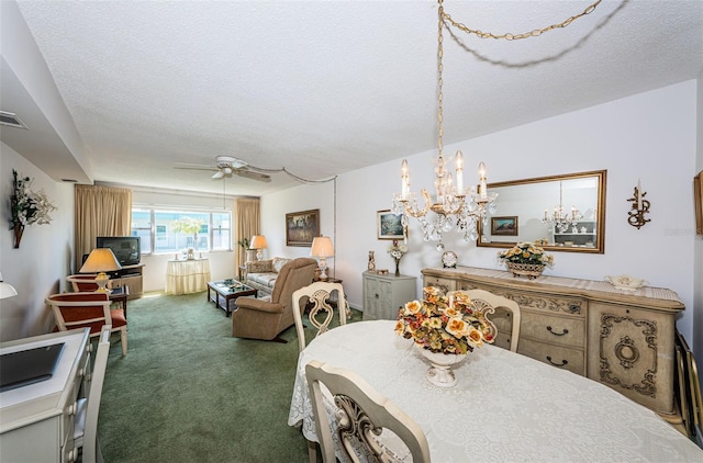 dining area with carpet flooring, ceiling fan with notable chandelier, and a textured ceiling