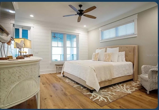 bedroom with ceiling fan and light wood-type flooring