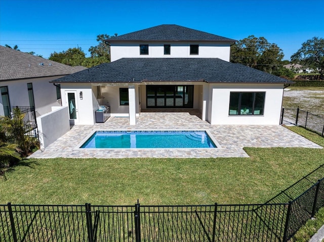 view of swimming pool with a lawn, a grill, and a patio area