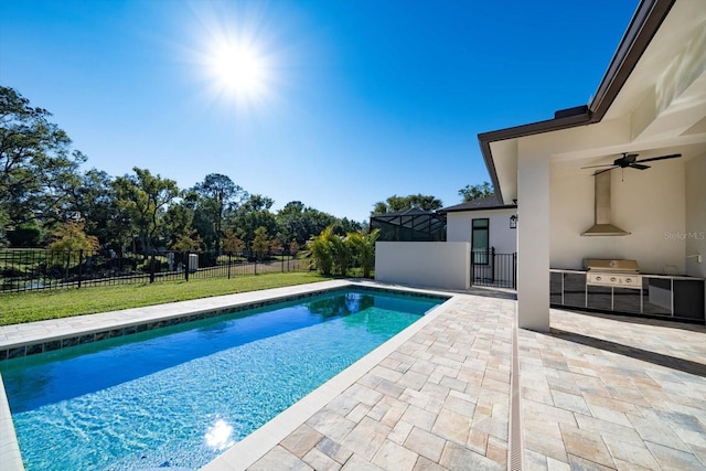 view of pool featuring a yard, a patio, glass enclosure, and area for grilling