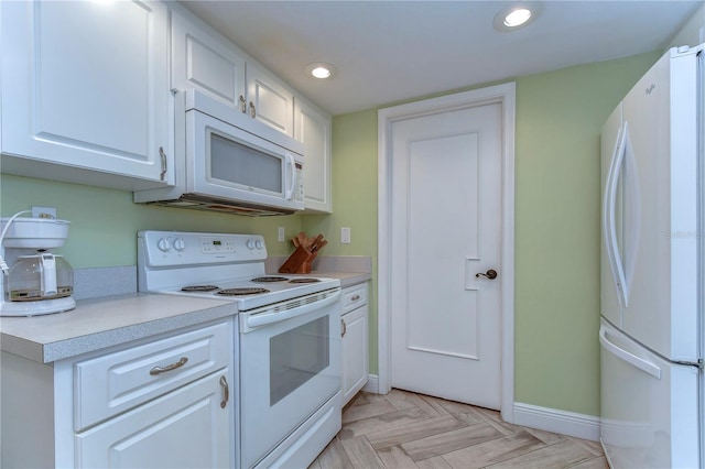 kitchen featuring white appliances, white cabinets, and light parquet floors