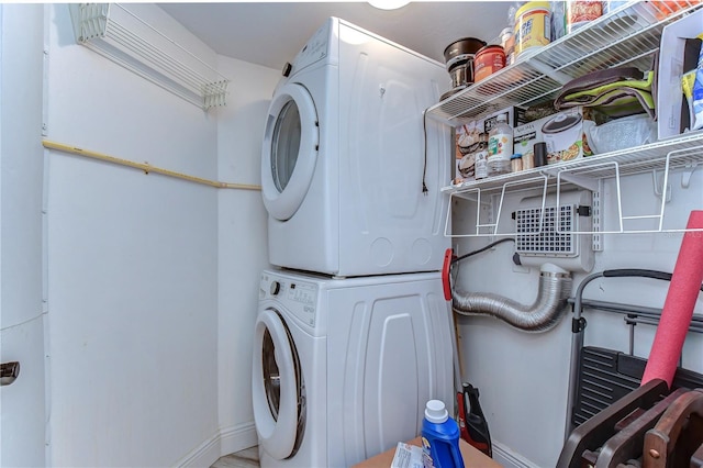 laundry area featuring stacked washer and clothes dryer