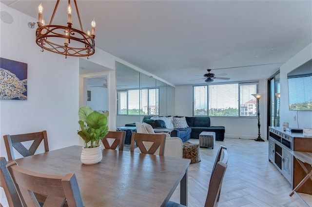 dining area featuring light parquet floors and ceiling fan with notable chandelier