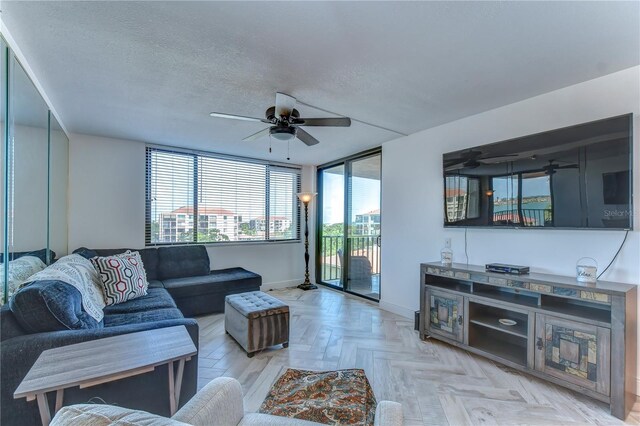 living room with floor to ceiling windows, light parquet flooring, a textured ceiling, and ceiling fan