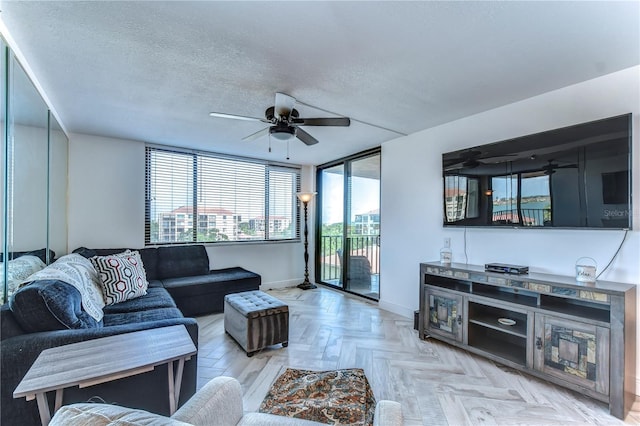 living room with floor to ceiling windows, light parquet flooring, a textured ceiling, and ceiling fan