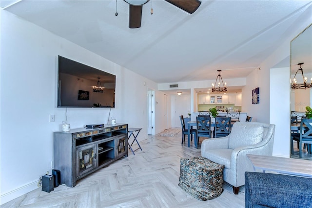 living room with light parquet flooring and ceiling fan with notable chandelier