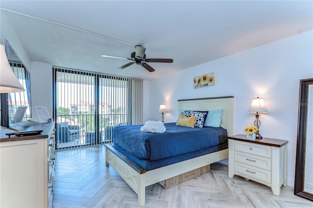 bedroom with access to outside, light parquet floors, and ceiling fan