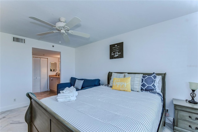 bedroom with ensuite bathroom and ceiling fan