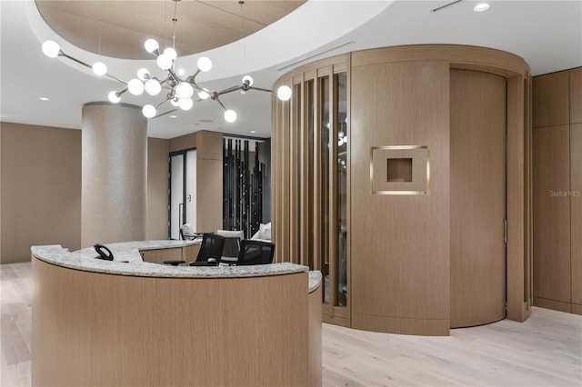 reception area featuring an inviting chandelier