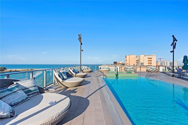 view of pool featuring a water view