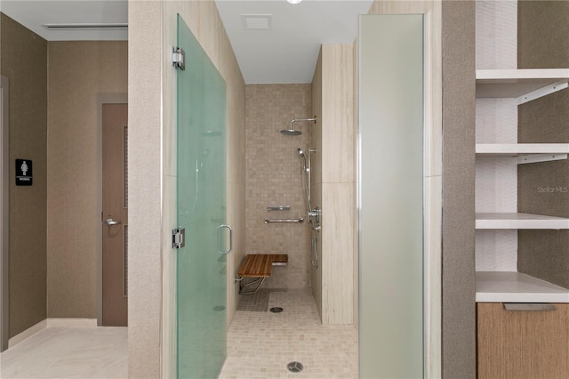 bathroom with a shower with door and tile flooring