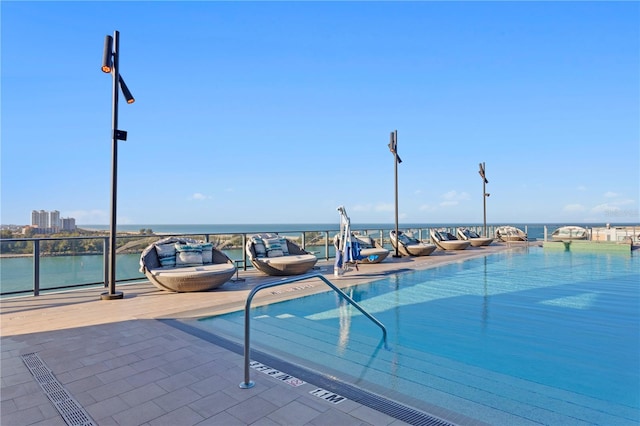 view of pool featuring a water view