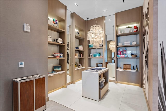 tiled office space with a notable chandelier