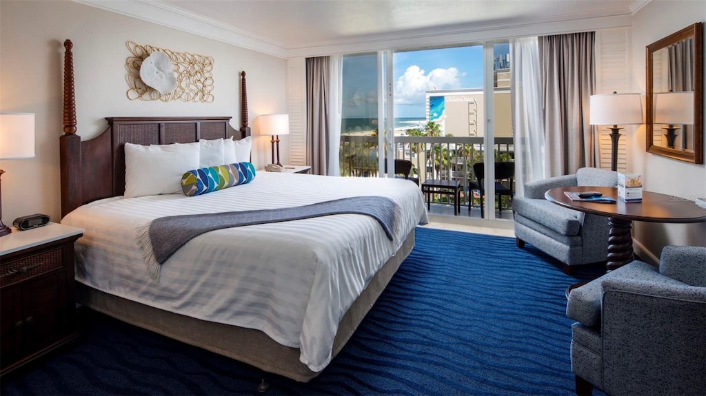 bedroom featuring ornamental molding and access to exterior