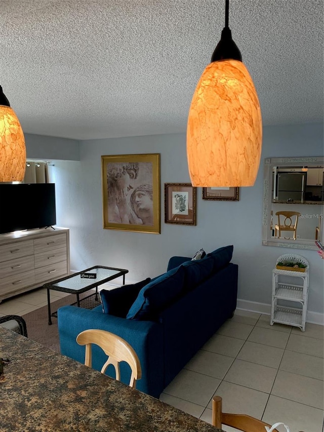 tiled living room featuring a textured ceiling