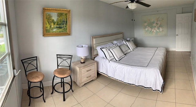 tiled bedroom featuring ceiling fan