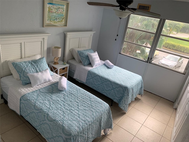 bedroom featuring light tile patterned flooring and ceiling fan