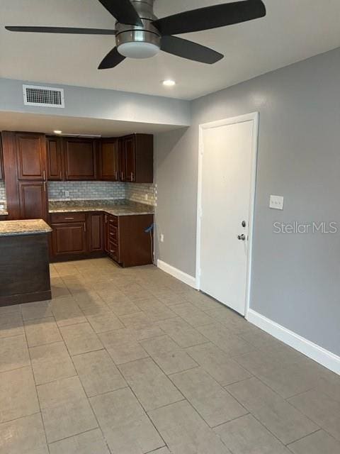 kitchen with backsplash, ceiling fan, light tile floors, and dark brown cabinetry