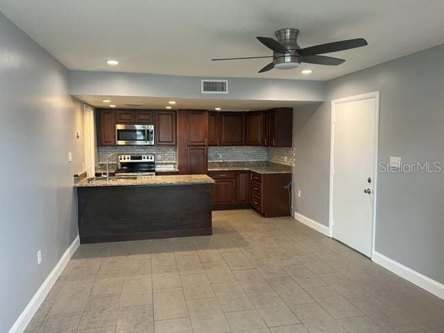 kitchen with ceiling fan, stainless steel appliances, light tile floors, dark brown cabinets, and tasteful backsplash