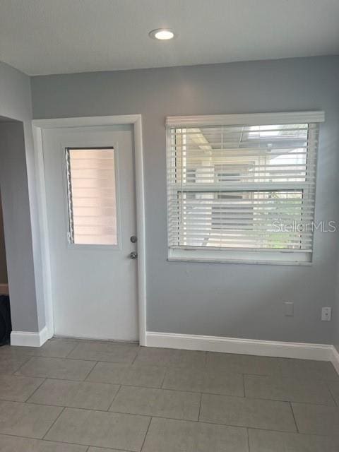 empty room featuring tile floors and a wealth of natural light