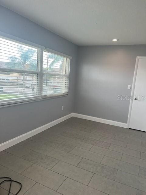 empty room featuring dark tile floors