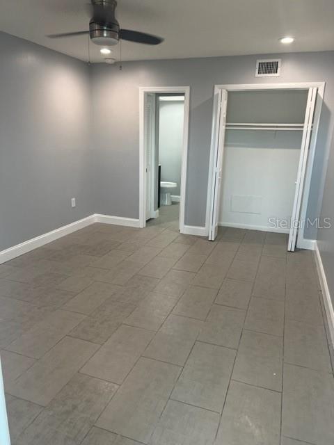 unfurnished bedroom with a closet, ceiling fan, and tile flooring