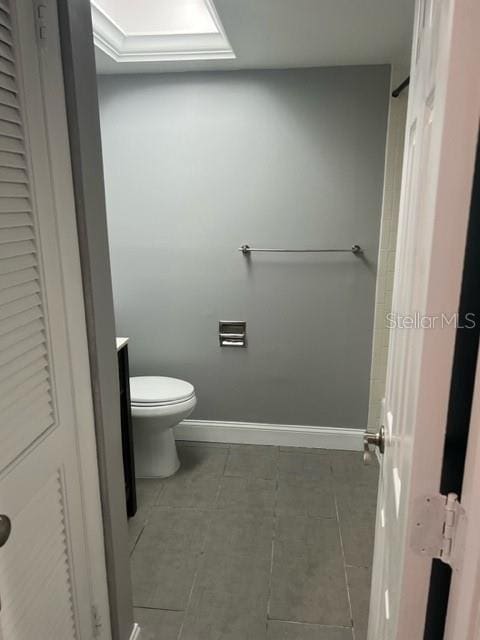 bathroom featuring toilet and tile floors