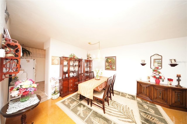 dining space with hardwood / wood-style flooring and an inviting chandelier