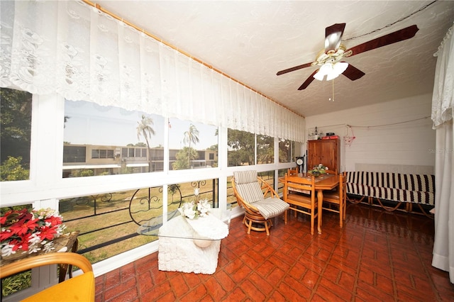 sunroom / solarium featuring ceiling fan