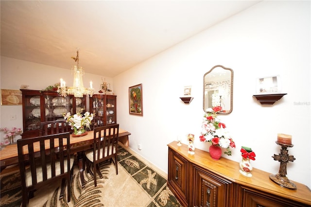 dining room with a notable chandelier and baseboards