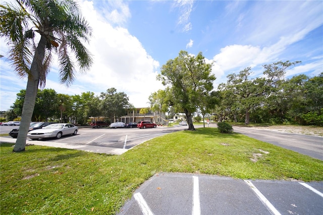 view of parking / parking lot with a yard