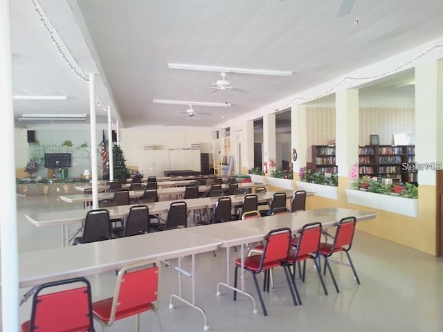 dining room with finished concrete floors and ceiling fan