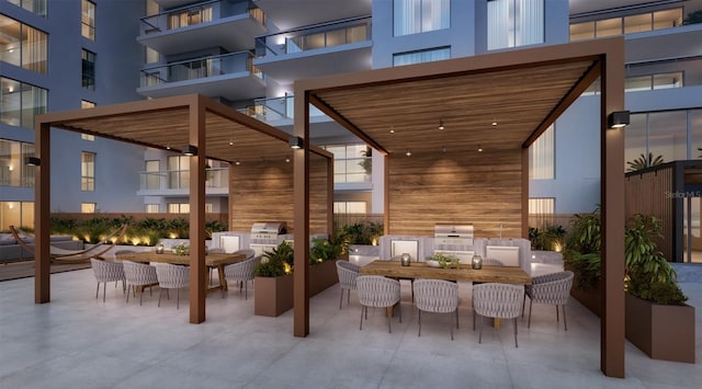 view of patio / terrace featuring a balcony, exterior kitchen, and outdoor lounge area