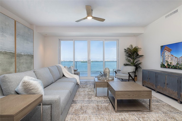 living room featuring a water view and ceiling fan