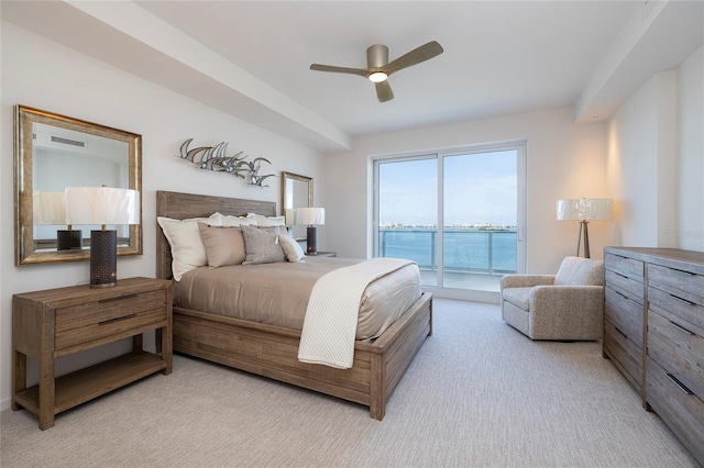 bedroom with ceiling fan, a water view, access to exterior, and light carpet