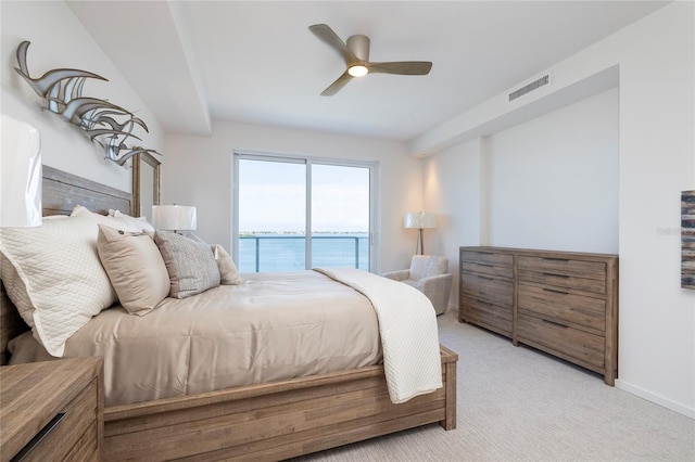 carpeted bedroom featuring ceiling fan, access to outside, and a water view