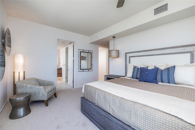 bedroom featuring ceiling fan, light carpet, and ensuite bathroom