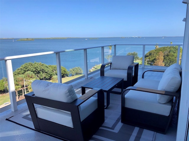 balcony with a water view and outdoor lounge area