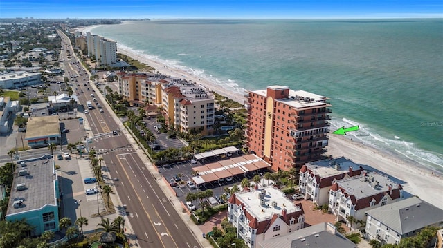 bird's eye view featuring a water view and a beach view